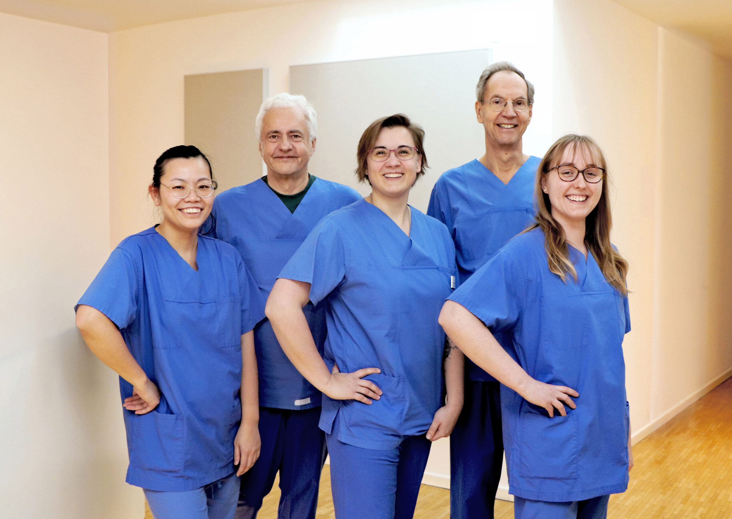Der ehemalige Chefarzt am Krankenhauses Reinbek, Prof. Dr. Stefan Jäckle (rechts hinten) und sein Leitender Oberarzt, Dr. Jens Stahmer (links) sind auch nach ihrer offiziellen Berentung als Gastroenterologen aktiv: Sie führen im Elisabethinum MVZ im CCB Bergedorf Magen- und Darmspiegelungen durch. Das MVZ gehört zum St. Adolf-Stift, für die beide mehr als zwanzig Jahre unter anderem in der Endoskopie tätig waren. Praxismanagerin Ulrike Möller (Mitte) führt ein Team von neun Medizinischen Fachangestellten, die sich während und nach dem Eingriff um die Patienten kümmern, darunter Joki Bischof (li.) und Lisa von Deyn (r.).